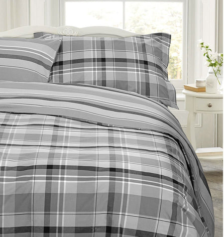 Parure copripiumino matrimoniale, singolo e piazza e mezza con un tartan grigio, bianco e nero. Federe e sacco copripiumino Daunex.