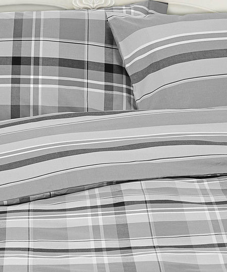 Parure copripiumino matrimoniale, singolo e piazza e mezza con un tartan grigio, bianco e nero. Federe e sacco copripiumino Daunex.
